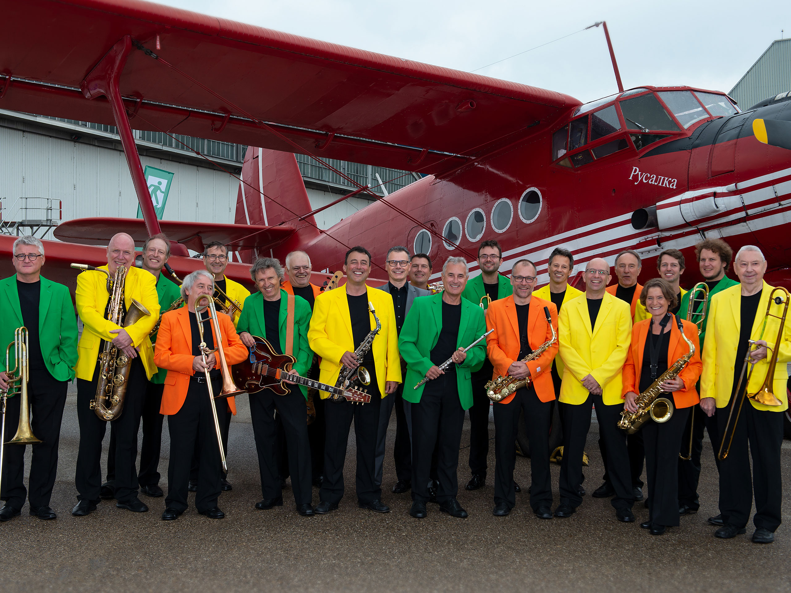 Orchestra in front of an airplane.
